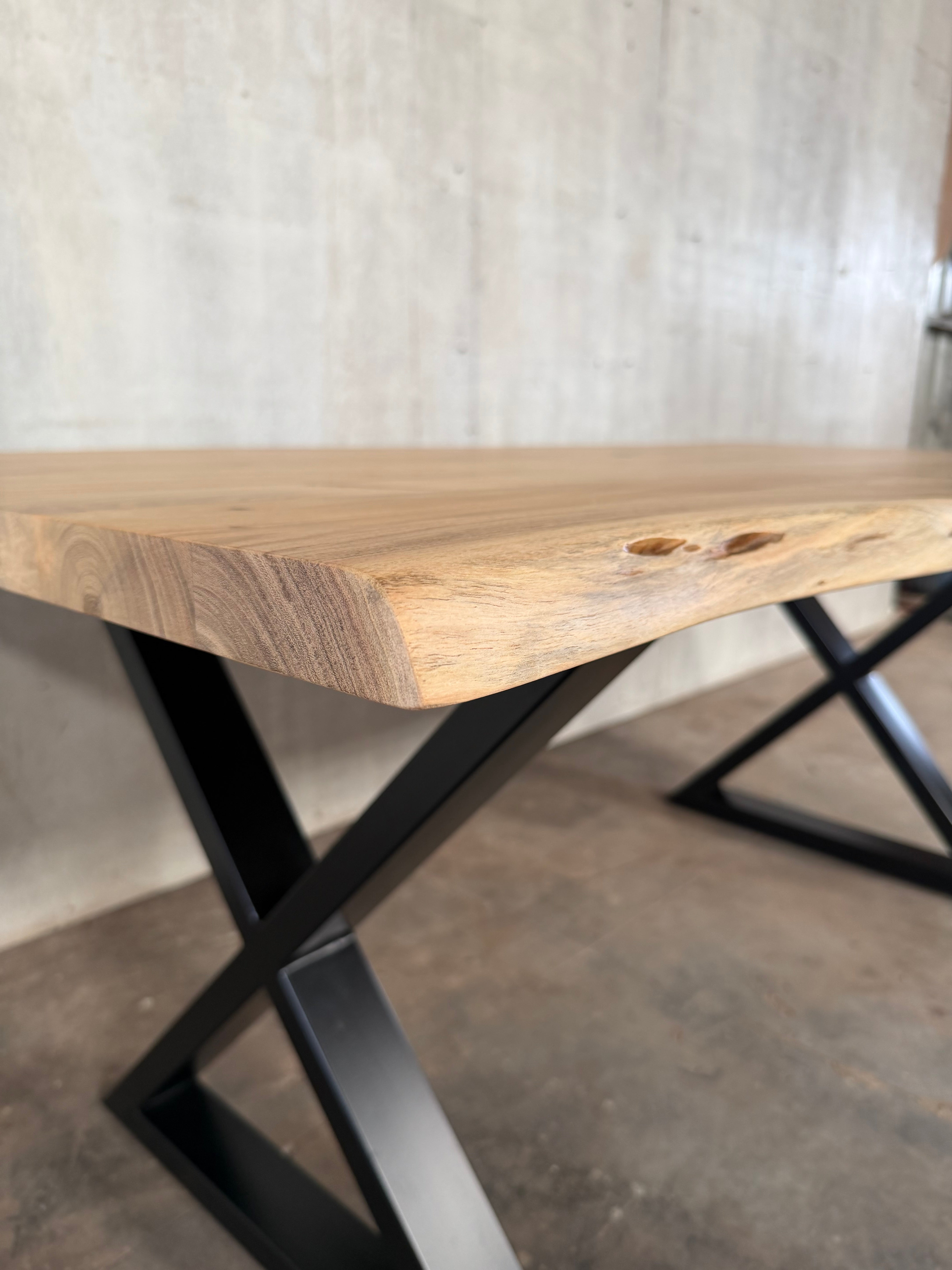 Angled view of 72 inch live edge acacia dining table