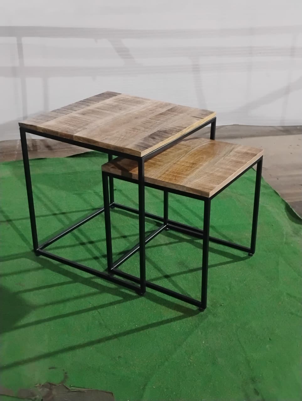 Side profile of Acacia nesting tables in dune finish