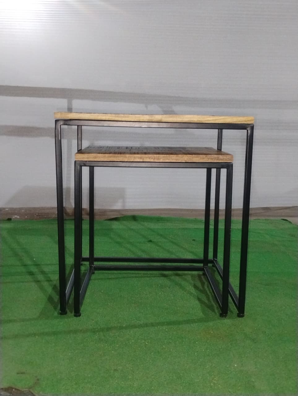 Small table nested under larger Acacia Studio side table