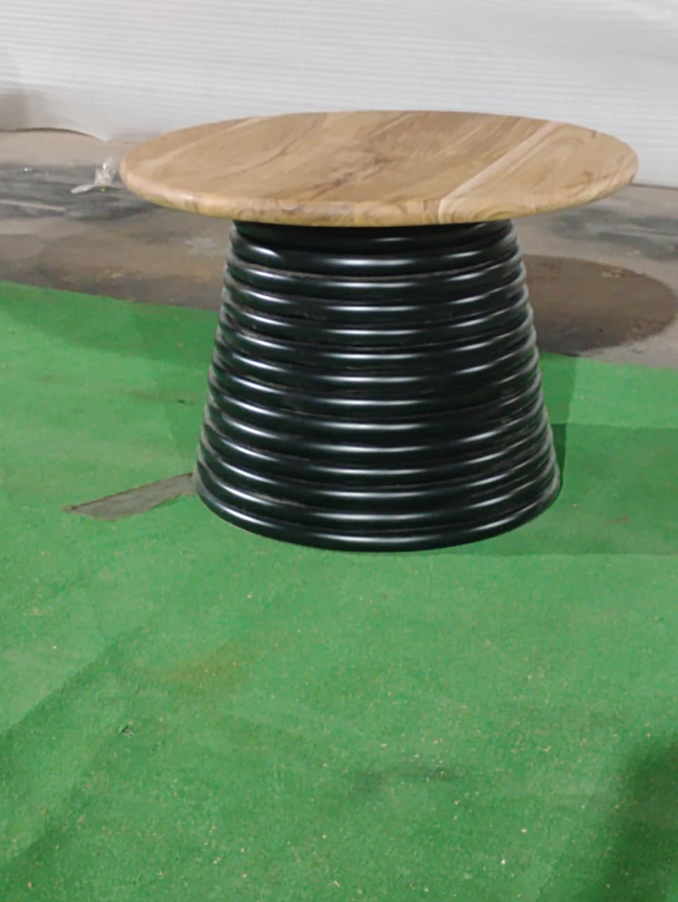 Sculpted black pedestal base of Strata 24 inch coffee table