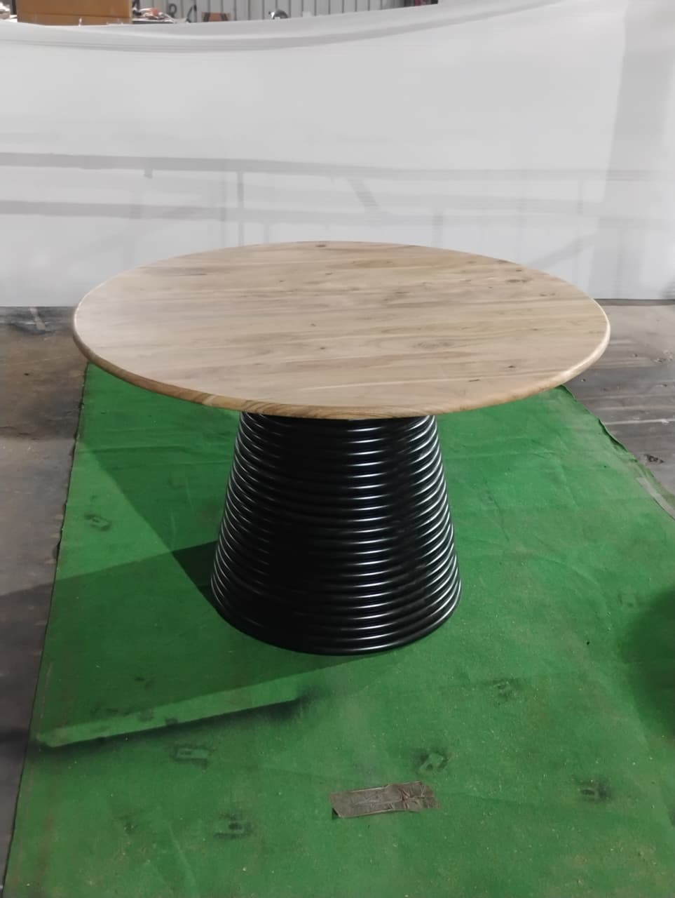 Angled view of Strata round 47 inch dining table with pedestal base