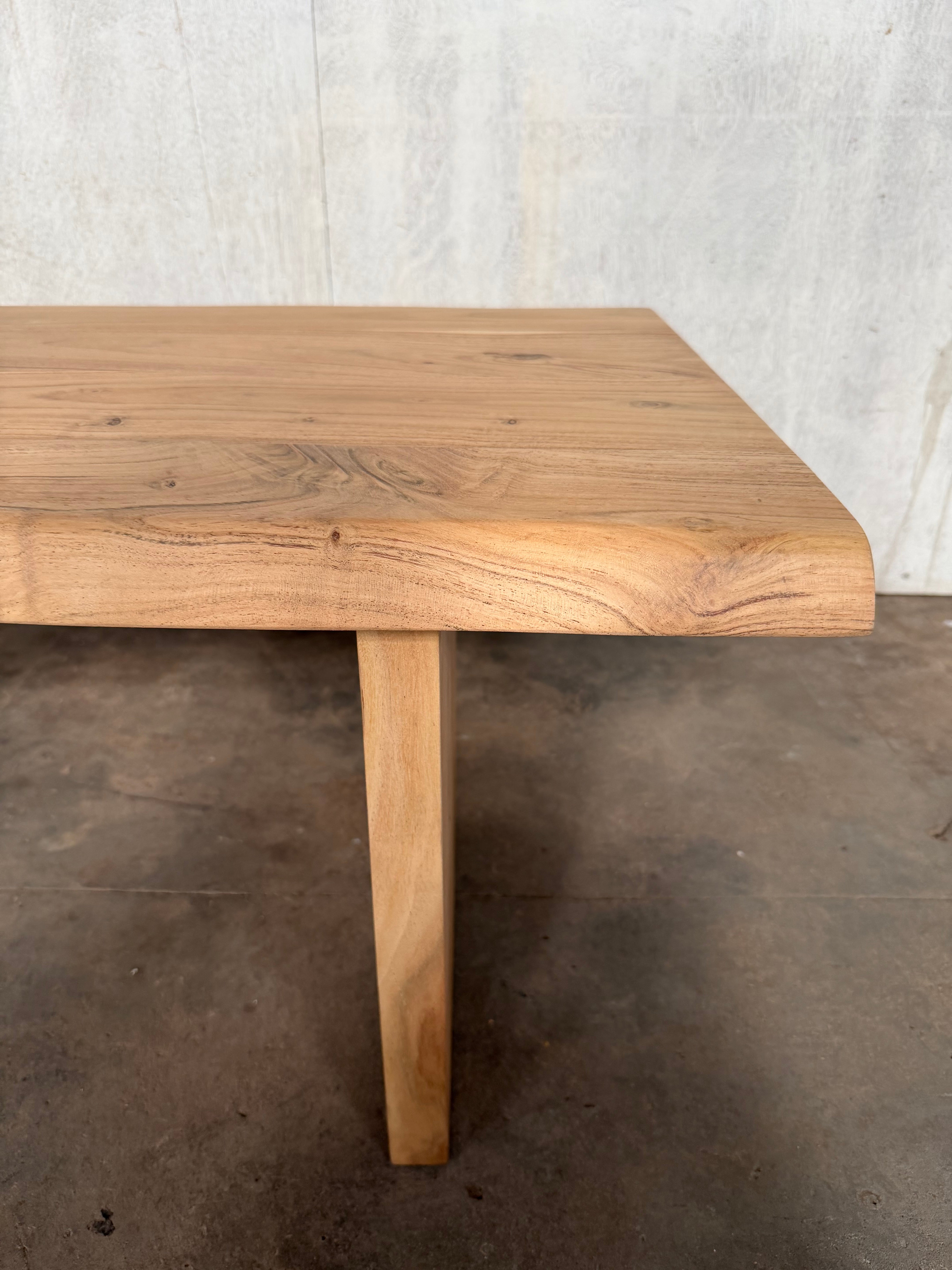 Wooden table against a concrete wall