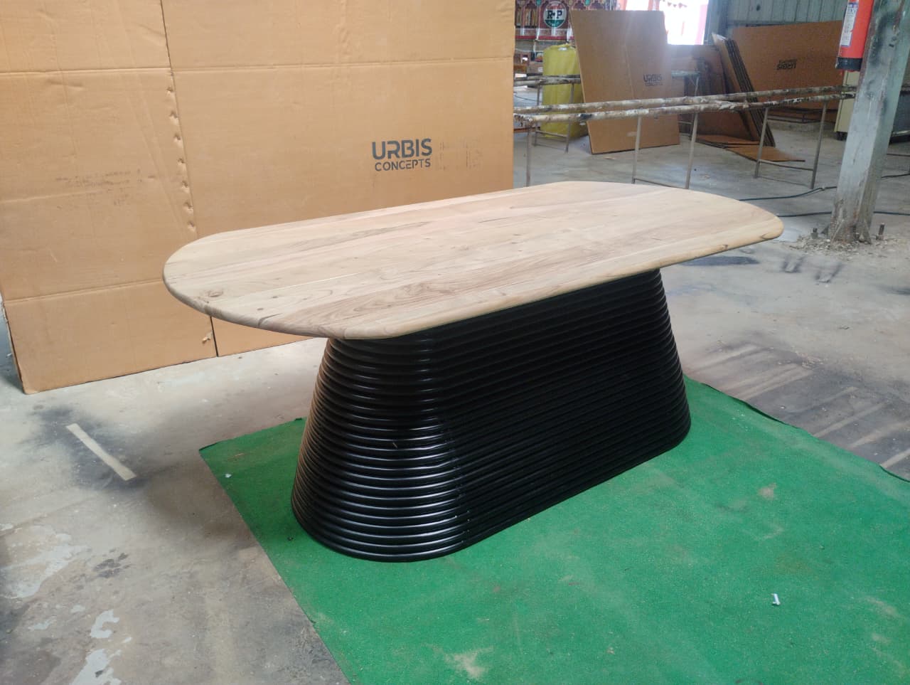 Angled view of Strata oval dining table in dune acacia wood