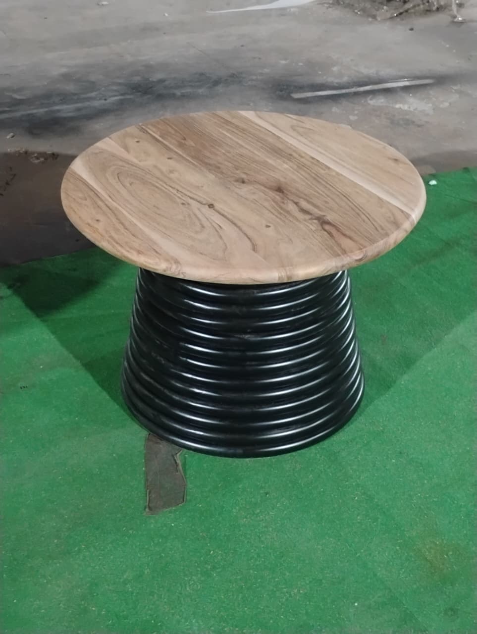 Angled view of Strata round 24 inch coffee table with pedestal base